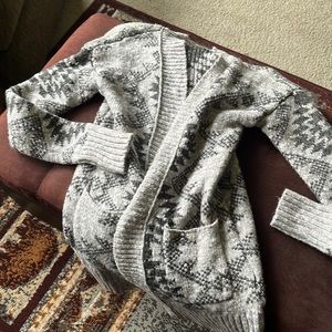 This fits like a small, beautiful Aztec cardigan